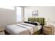 Bedroom with green headboard and wood nightstands at 1836 Grove St # 107, Denver, CO 80204