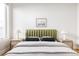 Bedroom with green headboard, wood nightstands, and a framed print at 1836 Grove St # 107, Denver, CO 80204