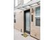 Modern entryway with frosted glass door and brick exterior at 1836 Grove St # 107, Denver, CO 80204