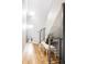 Light-filled hallway with modern bench and staircase at 1836 Grove St # 107, Denver, CO 80204