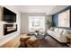 Open living space with fireplace and ample natural light at 1836 Grove St # 107, Denver, CO 80204