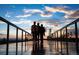 Modern community bridge at sunset, with silhouetted figures walking across and a beautiful sky reflection at 6322 N Malaya St, Aurora, CO 80019