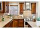 Modern kitchen with stainless steel appliances and corner sink at 10750 Fairbairn Way, Highlands Ranch, CO 80130