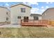 Back exterior view of the house, deck, and concrete patio at 1189 Fall River Cir, Longmont, CO 80504