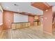 Spacious finished basement with wood-look floors, wet bar, and built-in cabinets at 1189 Fall River Cir, Longmont, CO 80504