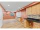 Brightly lit finished basement area featuring wood flooring, cabinets, countertops and large open space at 1189 Fall River Cir, Longmont, CO 80504