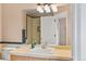 Bathroom featuring vanity with stylish fixtures, large mirror, and a shower with neutral tile at 1189 Fall River Cir, Longmont, CO 80504