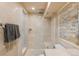 Modern bathroom featuring stone tile, glass shower, and contemporary fixtures for a luxurious feel at 1189 Fall River Cir, Longmont, CO 80504