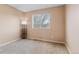 Bedroom with neutral walls and carpet, a modern lamp, and a window with a view at 1189 Fall River Cir, Longmont, CO 80504