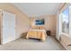 Bright bedroom featuring neutral walls, plush carpet, a comfy bed, and a sunlit window with views at 1189 Fall River Cir, Longmont, CO 80504