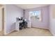 Bedroom with neutral walls and carpet, a desk/chair, and a window with a view at 1189 Fall River Cir, Longmont, CO 80504