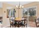 Cozy dining area with square table and views of the outdoor deck and backyard through sliding glass doors at 1189 Fall River Cir, Longmont, CO 80504