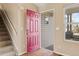 Bright foyer with hardwood floors, staircase and a red front door, creating a warm welcome at 1189 Fall River Cir, Longmont, CO 80504