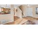 Open-concept foyer with views of the kitchen, dining area, and a staircase leading upstairs at 1189 Fall River Cir, Longmont, CO 80504