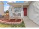 Inviting covered front porch featuring classic white pillars and a vibrant red door at 1189 Fall River Cir, Longmont, CO 80504
