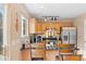 Well-lit kitchen featuring stainless steel appliances, wooden cabinets, and a granite countertop at 1189 Fall River Cir, Longmont, CO 80504