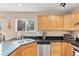 Kitchen area with black granite counters, stainless steel appliances, and wood cabinets at 1189 Fall River Cir, Longmont, CO 80504
