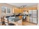 Bright kitchen with stainless steel appliances, wood cabinets, and a granite countertop at 1189 Fall River Cir, Longmont, CO 80504