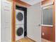 Convenient laundry room features stacked washer and dryer, a window and a closet for storage at 1189 Fall River Cir, Longmont, CO 80504
