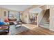 Inviting living room with a brown sectional couch, a decorative rug, and an open view of the staircase at 1189 Fall River Cir, Longmont, CO 80504