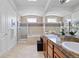 Elegant bathroom with double sinks, marble counters, soaking tub and glass shower at 45 N Ogden St # 309, Denver, CO 80218