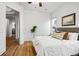 Sunlit bedroom featuring wood floors and a doorway to another room with a glimpse of the kitchen at 45 N Ogden St # 309, Denver, CO 80218