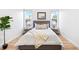 Bedroom with hardwood floors, large window, and modern decor at 45 N Ogden St # 309, Denver, CO 80218