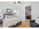 Cozy bedroom with hardwood floors, window, and open bathroom at 45 N Ogden St # 309, Denver, CO 80218