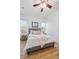Cozy bedroom with natural light from two windows and hardwood floors and ceiling fan at 45 N Ogden St # 309, Denver, CO 80218