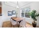 Dining room with wood table, six chairs, chandelier, and large window at 45 N Ogden St # 309, Denver, CO 80218