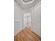 Hallway with archway and hardwood floors leading into other rooms with detailed trim work at 45 N Ogden St # 309, Denver, CO 80218