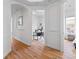 Open hallway with archways and wood floors leading into bedroom and office at 45 N Ogden St # 309, Denver, CO 80218