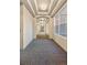 Long hallway featuring coffered ceilings, chandelier lighting, and patterned carpet at 45 N Ogden St # 309, Denver, CO 80218