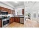 Bright kitchen with stainless steel appliances and open floor plan leading to the dining area at 45 N Ogden St # 309, Denver, CO 80218