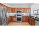 Modern kitchen featuring stainless steel appliances, granite countertops, and wooden cabinets at 45 N Ogden St # 309, Denver, CO 80218