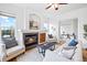 Living room with fireplace, hardwood floors, and a view of the adjacent office space at 45 N Ogden St # 309, Denver, CO 80218