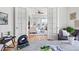 Bright living room showcasing French doors leading to a comfortable seating area with balcony and hardwood flooring at 45 N Ogden St # 309, Denver, CO 80218