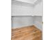 Empty walk in closet featuring wood floors, shelves and a hanging bar at 45 N Ogden St # 309, Denver, CO 80218