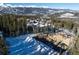 Aerial view of the construction site with mountain views, surrounded by trees, and foundation work at 528 N Fuller Placer, Breckenridge, CO 80424
