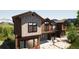 Exterior elevation view showing architectural details, decks, and the natural stone landscaping features of this mountain home at 528 N Fuller Placer, Breckenridge, CO 80424