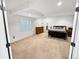 Spacious basement bedroom with neutral carpet, large closet, and ample natural light at 7722 E 6Th Pl, Denver, CO 80230