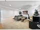Finished basement with a comfortable couch, a modern workstation, and neutral carpet at 7722 E 6Th Pl, Denver, CO 80230