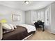 Cozy bedroom with carpet, a quaint desk by the windows, and a comfortable bed at 7722 E 6Th Pl, Denver, CO 80230
