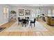 Bright dining room with a glass table, wood floors, and a large decorative rug at 7722 E 6Th Pl, Denver, CO 80230