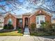Charming brick home featuring a well-manicured lawn and inviting entrance at 7722 E 6Th Pl, Denver, CO 80230