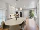 Well-equipped kitchen with white cabinets, center island, and stainless appliances at 7722 E 6Th Pl, Denver, CO 80230