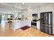 Open kitchen featuring stainless steel appliances and a view to the living room at 7722 E 6Th Pl, Denver, CO 80230