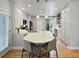 Modern kitchen with quartz countertops, stainless appliances, and island seating at 7722 E 6Th Pl, Denver, CO 80230