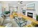 Cozy living room with fireplace, hardwood floors, and bright, airy feel at 7722 E 6Th Pl, Denver, CO 80230