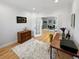 Bright home office features hardwood floors, modern furniture, and open entry to the dining room at 7722 E 6Th Pl, Denver, CO 80230